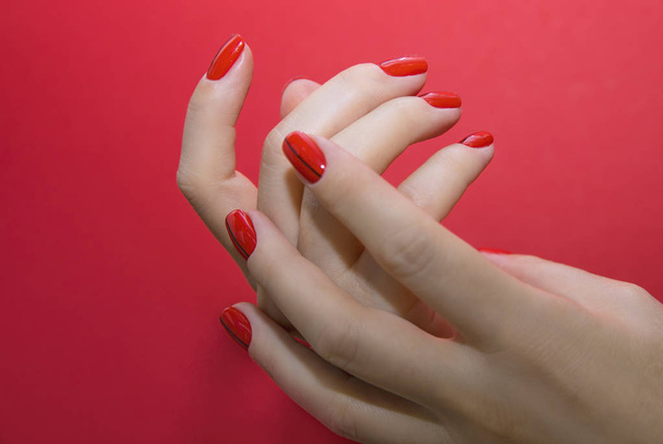 Beautiful female hands with red manicure and nail isolated - Foto, immagini