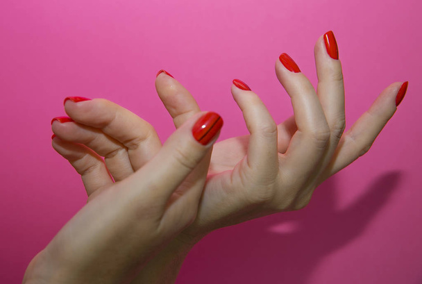 Beautiful female hands with red manicure and nail isolated - Photo, Image