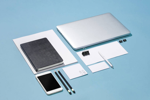 The laptop, pens, phone, note with blank screen on table - Foto, Imagem