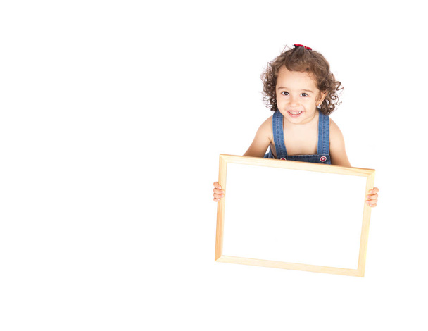 Little cute girl holding empty frame in hand - Foto, immagini