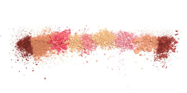 Samples of dry blush, powder, bronzers and highlighter scattered in a line isolated on a white background - Photo, Image