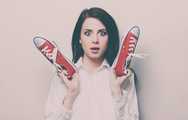 Young woman with gumshoes - 写真・画像