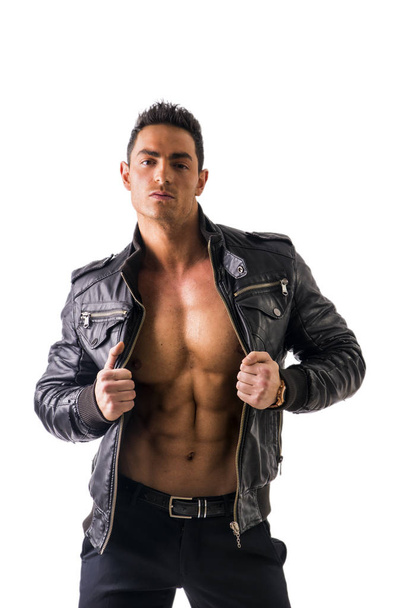 Handsome young man wearing leather jacket on naked torso, isolated - Valokuva, kuva