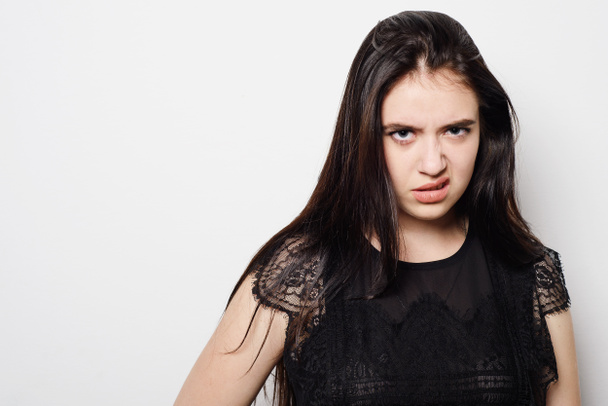 Closeup portrait young woman with bad attitude, looking at you isolated grey background. - 写真・画像