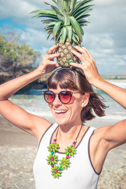 Tropical summer woman with pineapple. Outdoors, ocean, nature. Bali island paradise. - Photo, Image