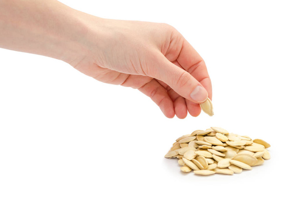 female hand takes or gives pumpkin seeds. - Photo, Image