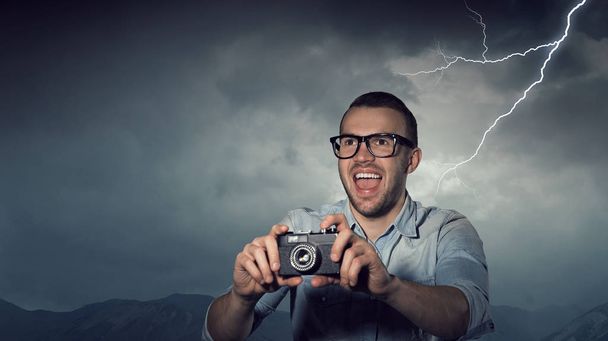 Guy with retro photocamera. Mixed media - Foto, afbeelding