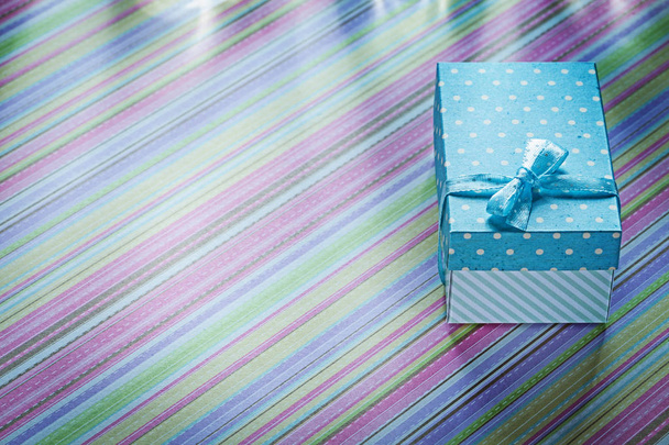 Gift box on striped tablecloth horizontal image celebrations con - Foto, Imagen