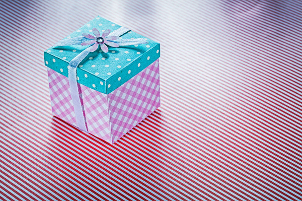 Gift box on striped fabric background holidays concept - Foto, imagen