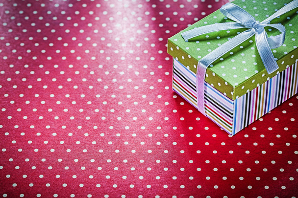 Gift box on red textile top view celebrations concept - Foto, Imagem