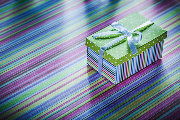 Cardboard box with gift on striped fabric celebrations concept - Photo, Image