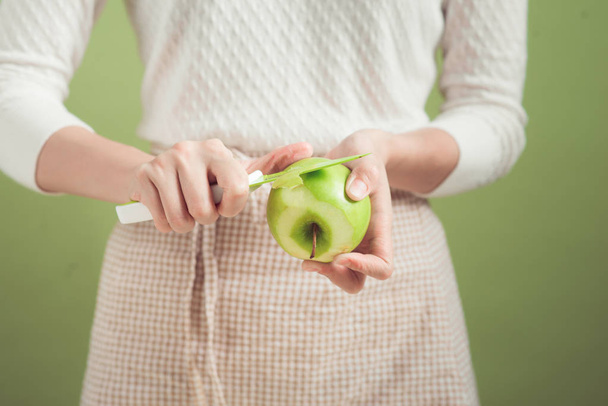 woman peeling green apple - Photo, Image