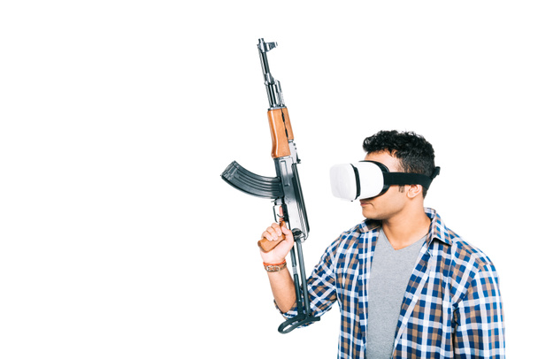 ο άνθρωπος στο σετ κεφαλής εικονικής πραγματικότητας με το τουφέκι - Φωτογραφία, εικόνα