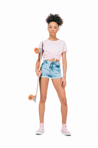 african american girl holding skateboard - 写真・画像