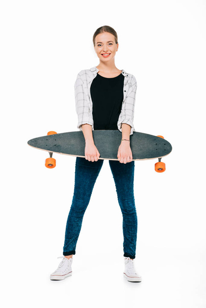 smiling girl holding skateboard - Foto, imagen
