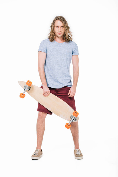 handsome young man with skateboard - Fotó, kép