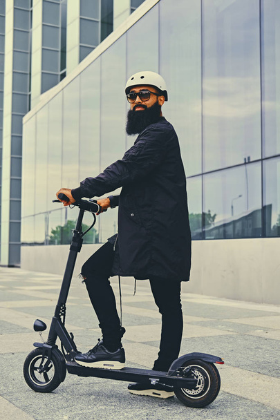 Stylish bearded man on electric scooter - Foto, Imagen