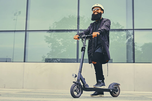 Stylish bearded man on electric scooter - Zdjęcie, obraz