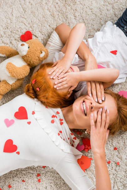 mother and daughter with hearts and teddy bear - Photo, Image