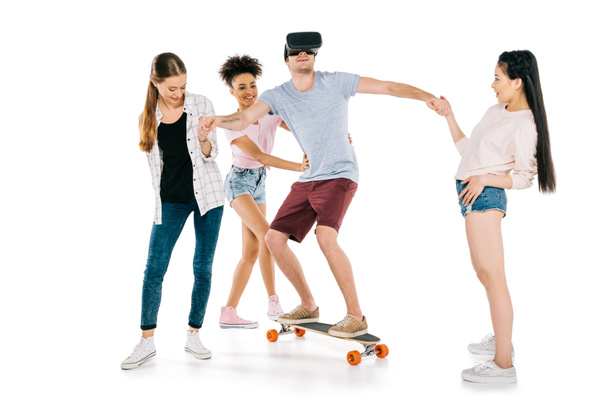 girls and young man on skateboard - Photo, Image