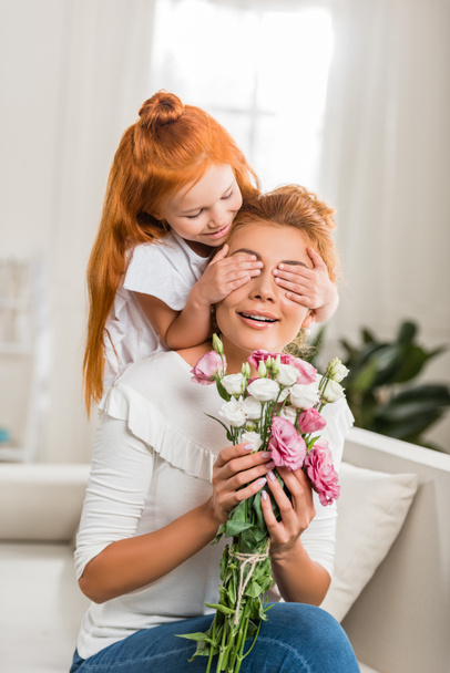 daughter covering mothers eyes - Photo, Image