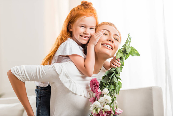 happy mother with flowers and daughter - Photo, Image