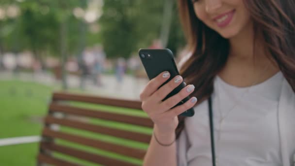 A Beautiful Brunette Using a Mobile Phone Outdoors - Footage, Video