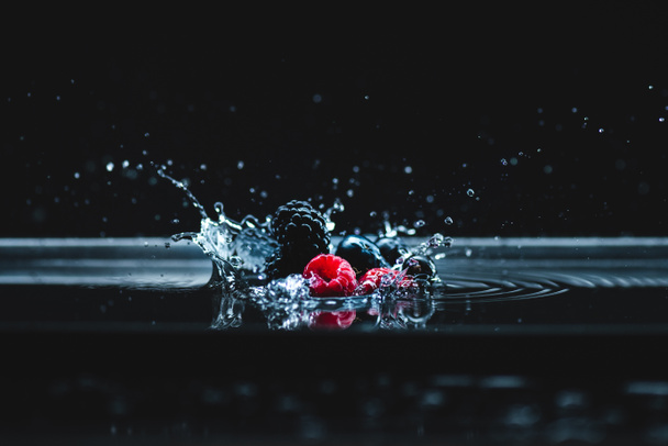 ripe berries falling in water - Fotoğraf, Görsel