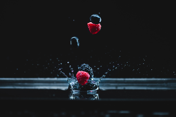ripe berries falling in water - Фото, зображення