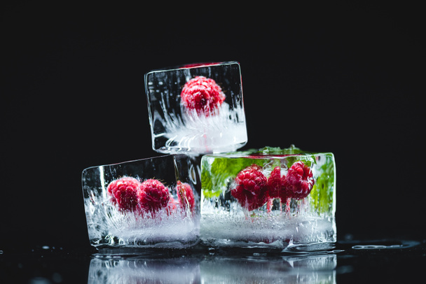 raspberries frozen in ice cubes - Photo, Image