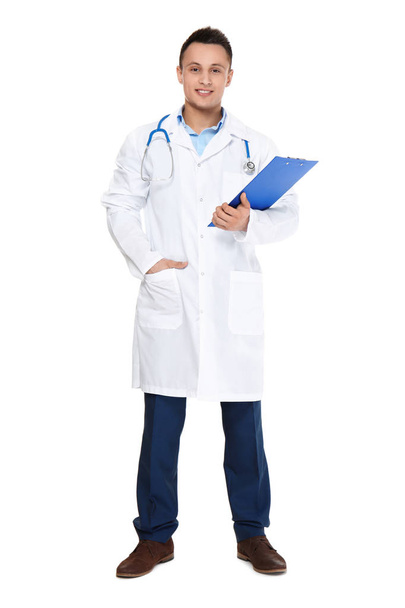 Young male doctor with stethoscope and clipboard on white background - Photo, image