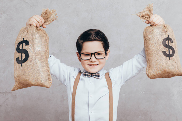 little boy with moneybags - Foto, Bild