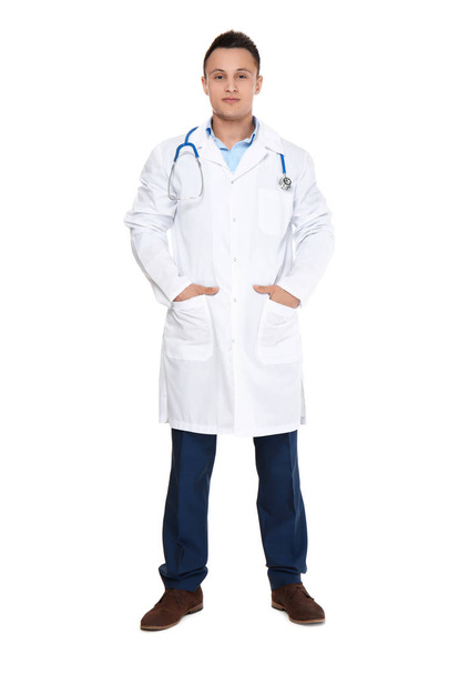 Young male doctor with stethoscope on white background - Фото, изображение