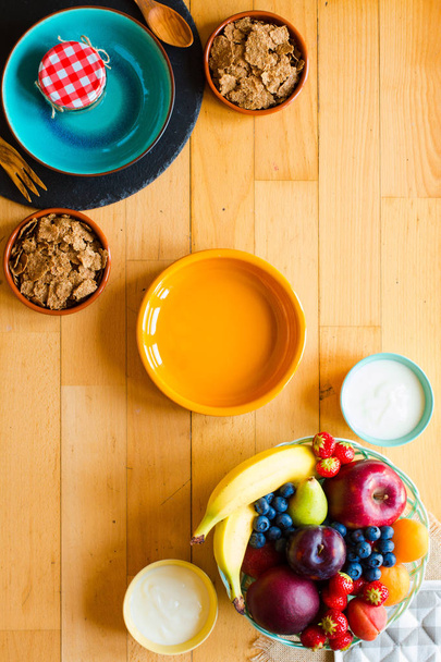 Bowl of fresh fruit with banana, apple, strawberries, apricots,  - Photo, image