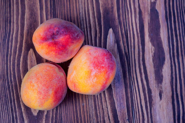 Juicy peaches on wooden background - Photo, Image