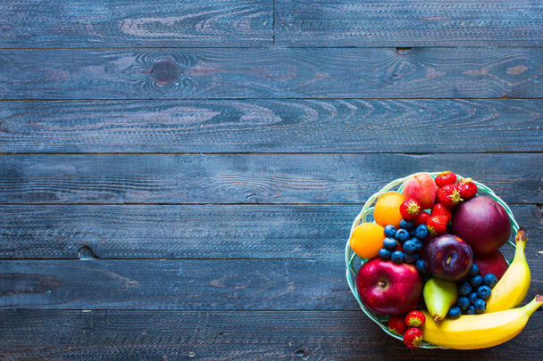 Bowl of fresh fruit with banana, apple, strawberries, apricots,  - Фото, зображення