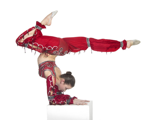 A young contortionist,circus performer in a red suit. - Foto, Bild