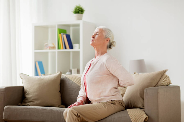 senior woman suffering from pain in back at home - Φωτογραφία, εικόνα