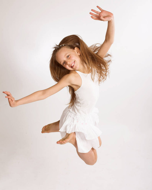 girl jumps on a white background - Foto, Imagen