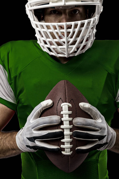 Football Player with a green uniform - Фото, изображение