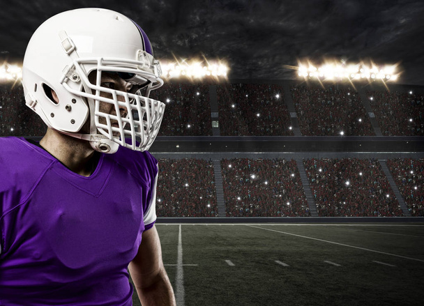Football Player with a purple uniform - Фото, изображение