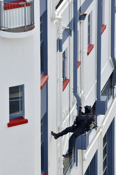 Counter-terrorism police officer abseiling a building - Photo, Image