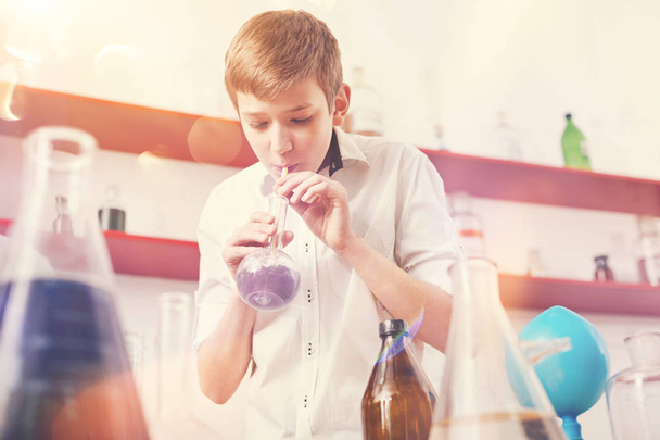Interested in result teenager blowing into bottle - Fotoğraf, Görsel