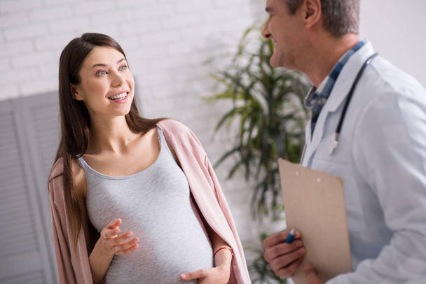 Joyful pregnancy being surprised from her doctor - Foto, Bild