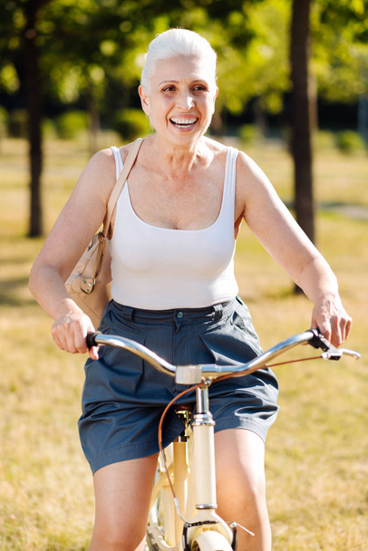 Delighted blonde riding new bicycle - Φωτογραφία, εικόνα