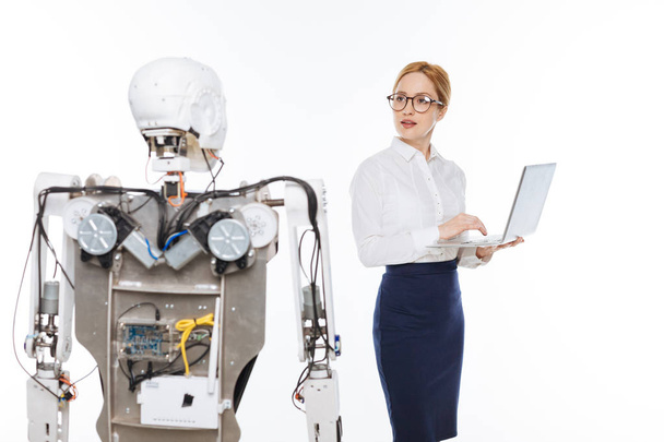 Savvy talented scientist coding the functions of the robot - Foto, Bild