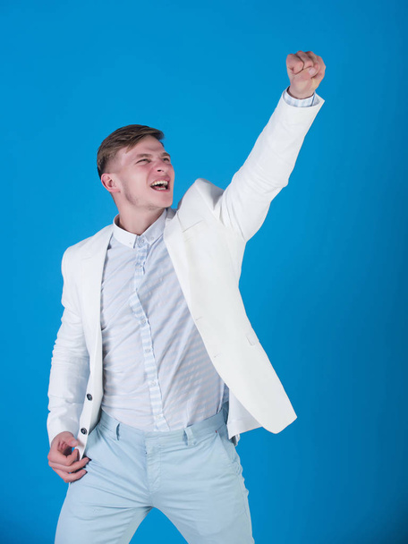 Businessman celebrating achievement on blue background - Zdjęcie, obraz