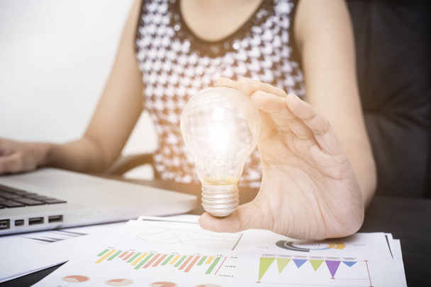 Business women hand holding light bulb, concept of new ideas  - Photo, Image