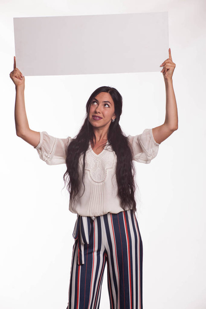 Young happy woman showing presentation, pointing on placard - Zdjęcie, obraz