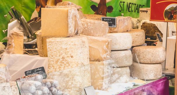 Display of French cheeses and sausages on a street market - Foto, Bild